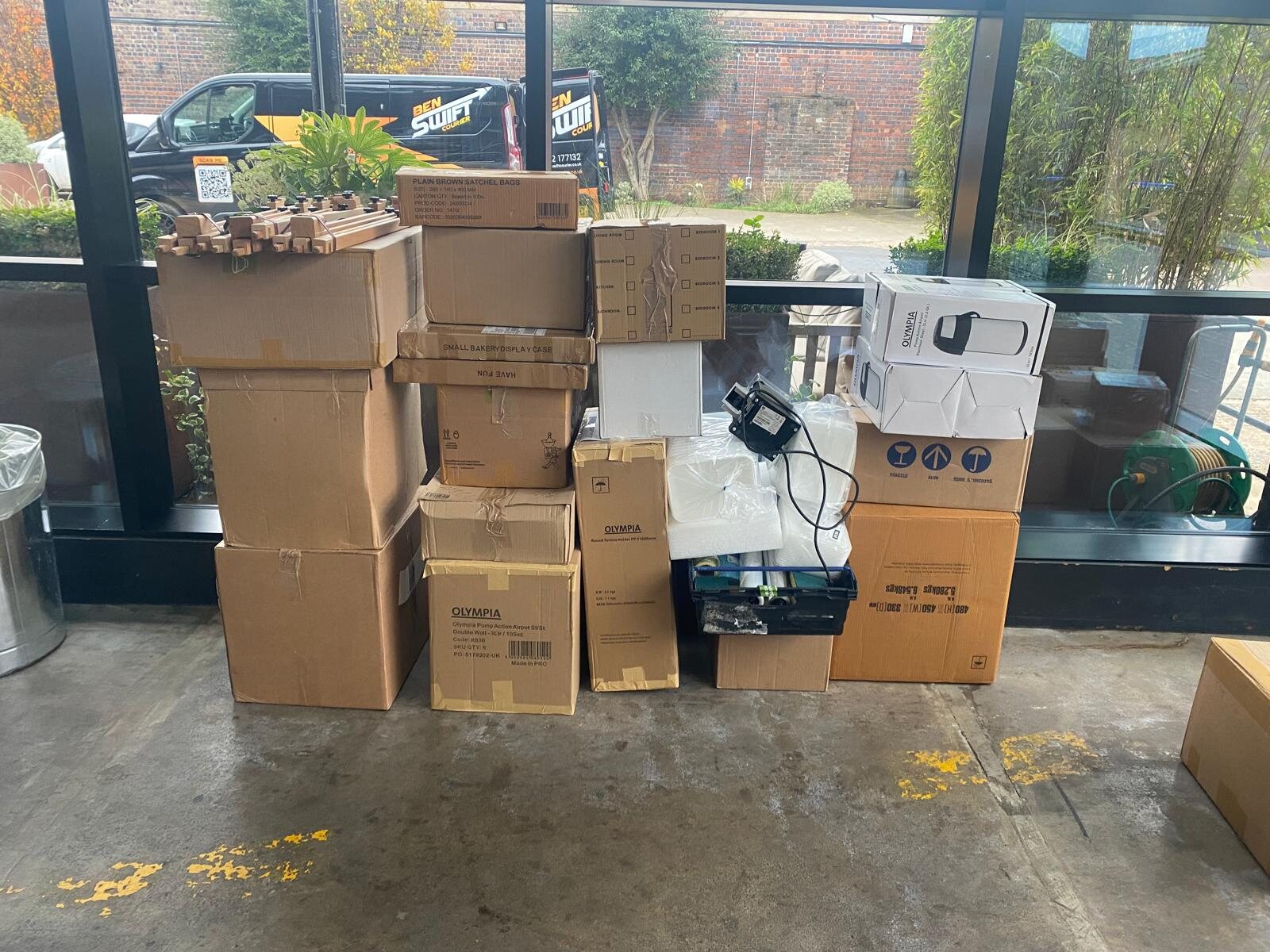 Business delivery boxes prepared with a Ben Swift Courier van outside